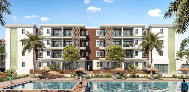 Impressie van de gevel van Vista Valley met balkons, baksteen en mashrabiya-panelen aan het zwembad